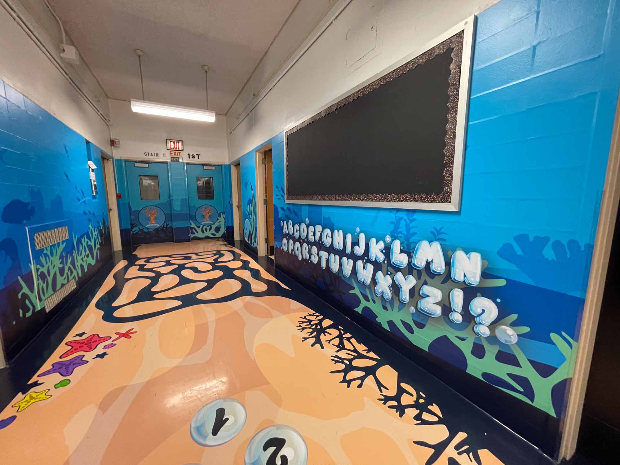 floor wrap and wall wraps featuring underwater theme with an alphabet wall with letters made from bubbles